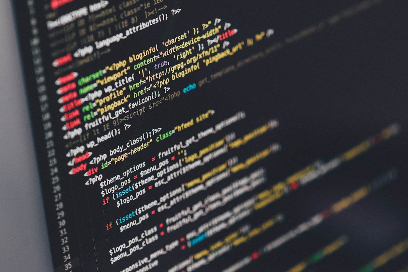 Source code on a screen, reviewed by an engineer
