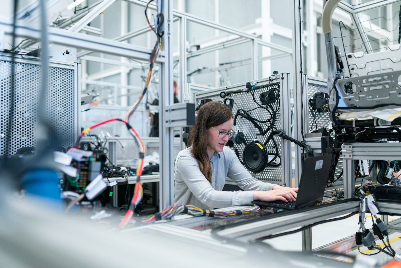 A senior engineer working at a real operations workstation on the factory floor
