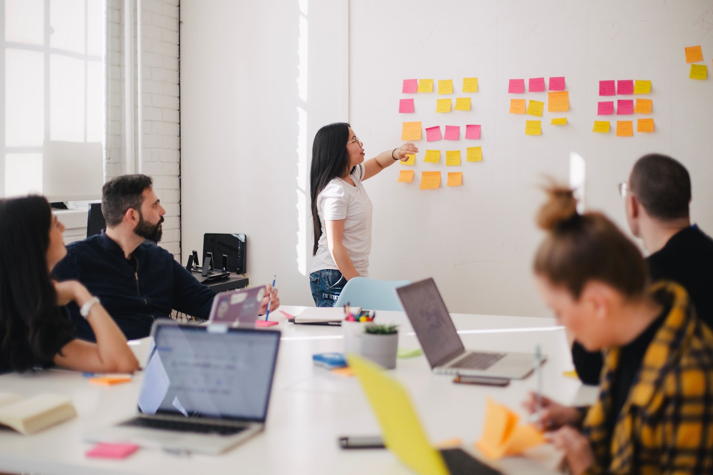 A team planning a sprint at a whiteboard covered in sticky notes
